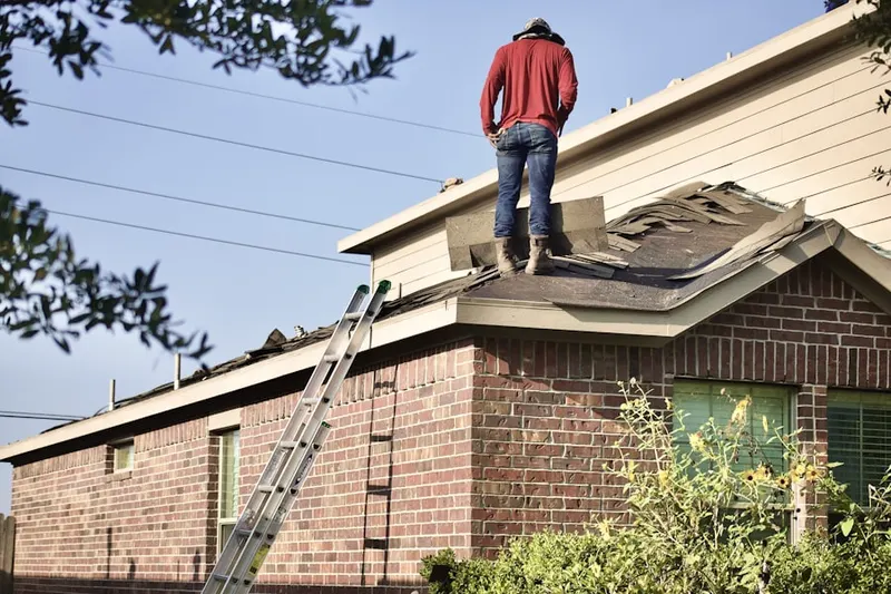 Professional roofer working on a residential roof in Belvedere Homes